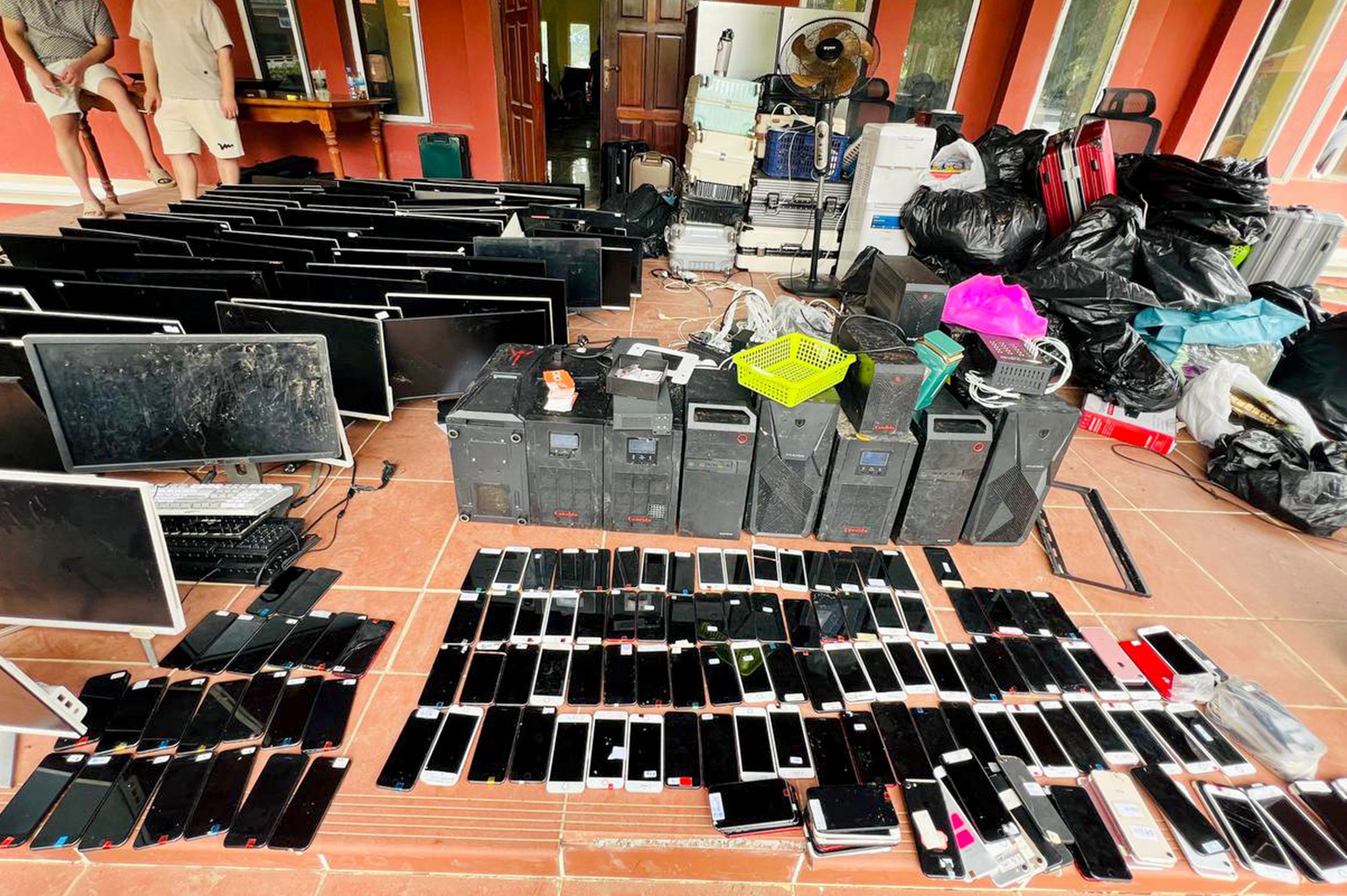 Electronic devices seized during a raid on a scam centre in Cambodia's Kandal province last July (Photo : Pool/AFP)