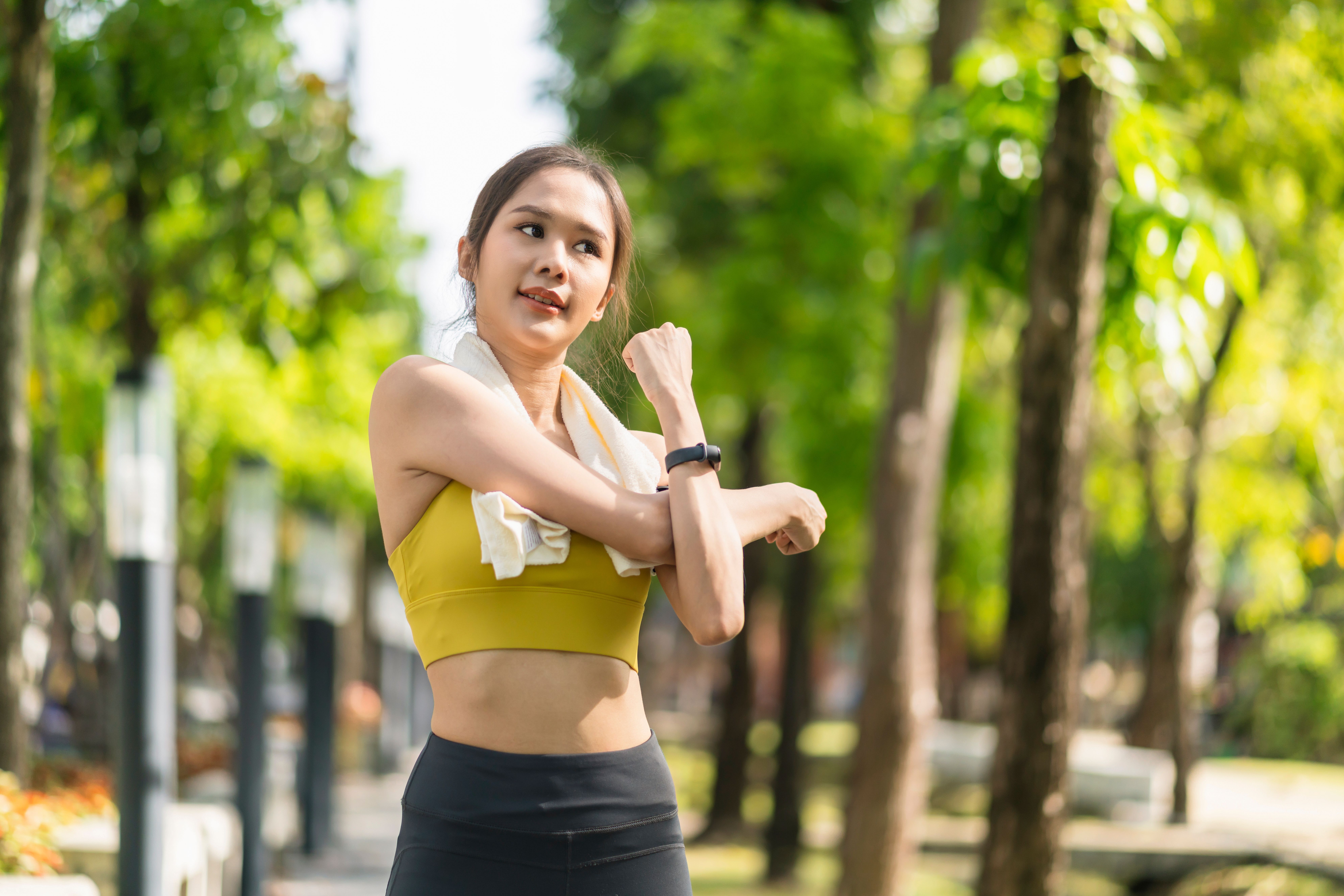 asian-cheerful-young-adult-attractive-strong-morning-stretching-before-runin-park-sports-concept-healthy-lifestyle-young-fitness-woman-runner-stretching-before-run-park.jpg