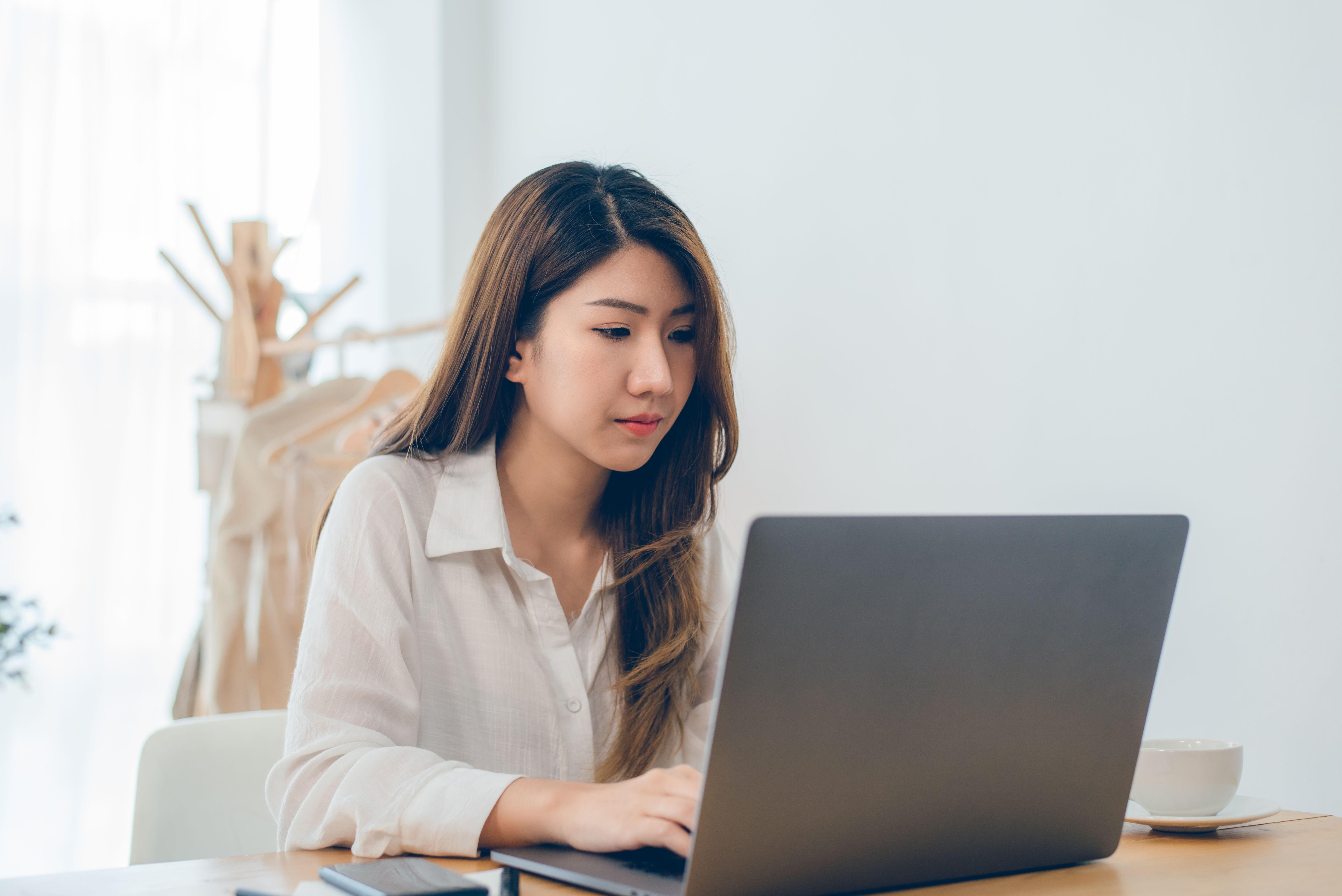 asian-woman-working-laptop-while-home-office-work-space